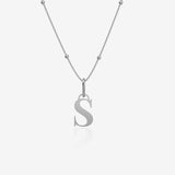 Silver necklace with a 'S' pendant on a light gray background