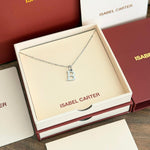 Silver necklace with a 'B' pendant in an Isabel Carter box.