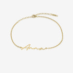 Gold name bracelet with 'Anna' engraving on a white background