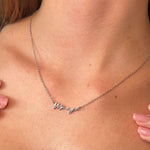 Silver signature necklace with 'Macy' pendant on a person's neck