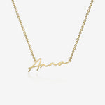 Gold necklace with 'Anna' engraved on a white background