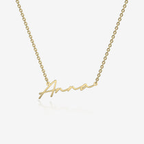 Gold necklace with 'Anna' engraved on a white background