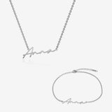 Silver name necklace and bracelet set with 'Anna' engraving on a white background