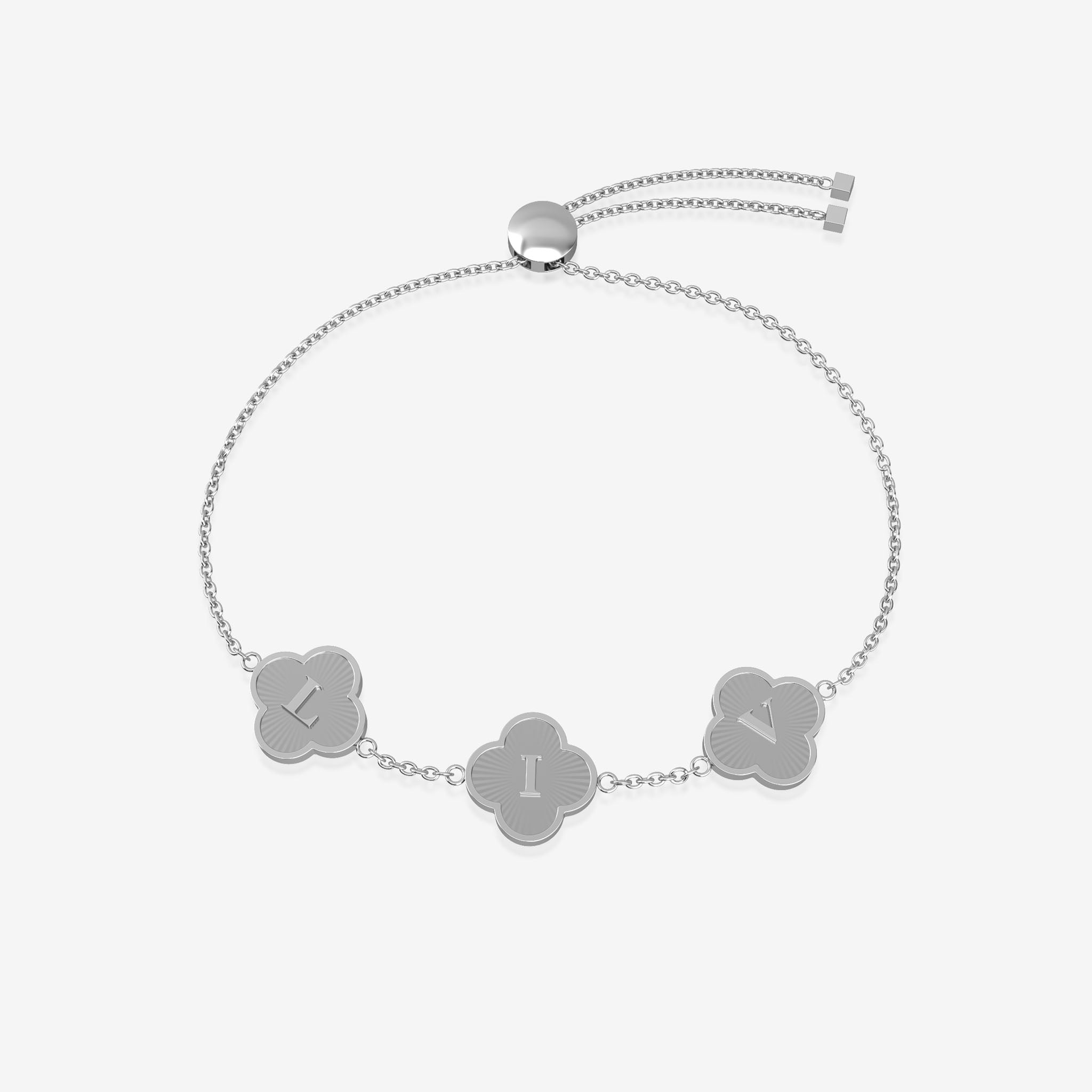 Silver bracelet with clover-shaped charms displaying initials on a light gray background