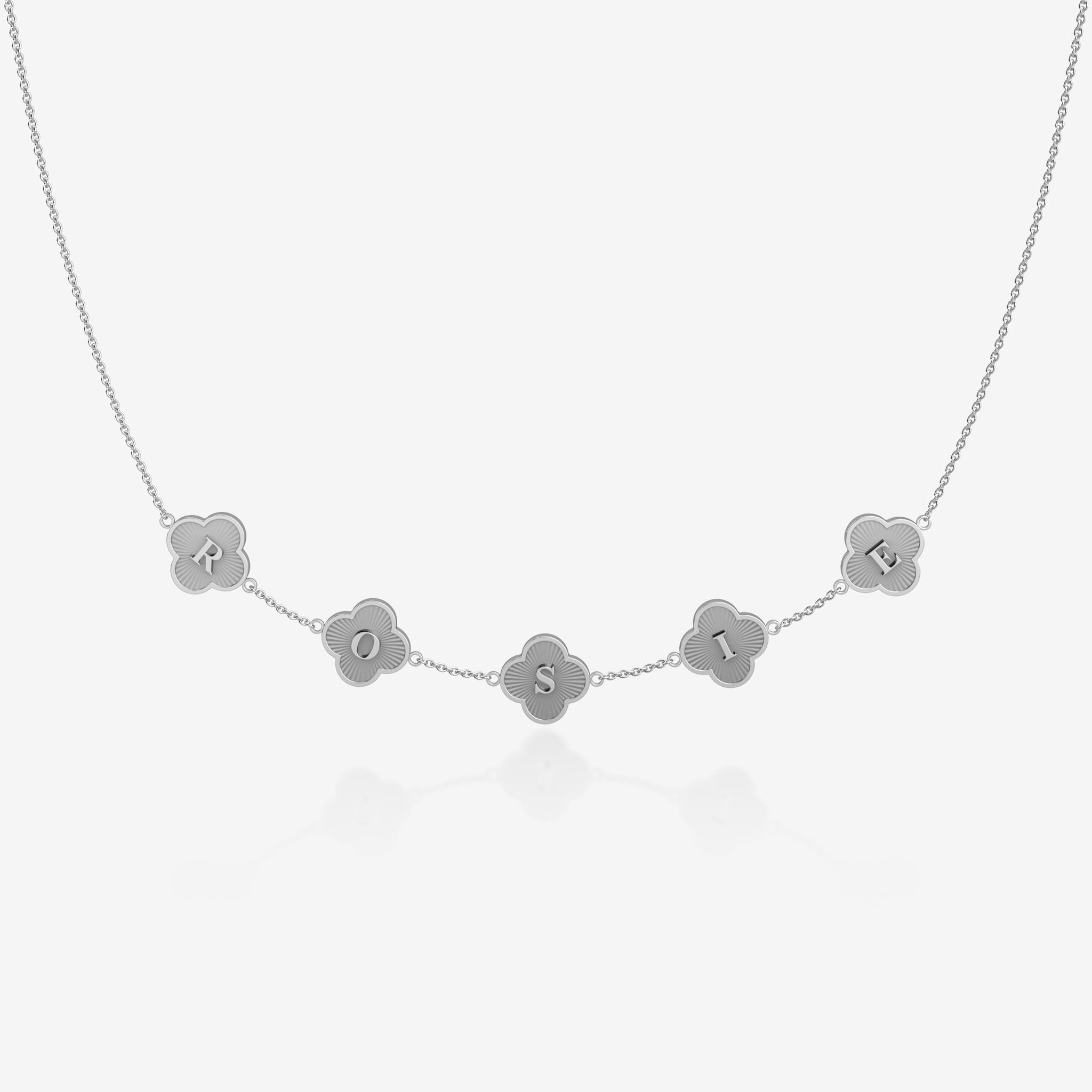 Silver clover necklace with engraved letters on a white background