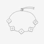 Silver bracelet with clover-shaped charms displaying letters on a white background