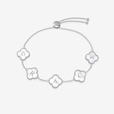 Silver bracelet with clover-shaped charms displaying letters on a white background