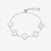 Silver bracelet with clover-shaped charms displaying letters on a white background