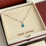 Necklace with a march aquamarine birthstone pendant in an 'Isabel Carter' box