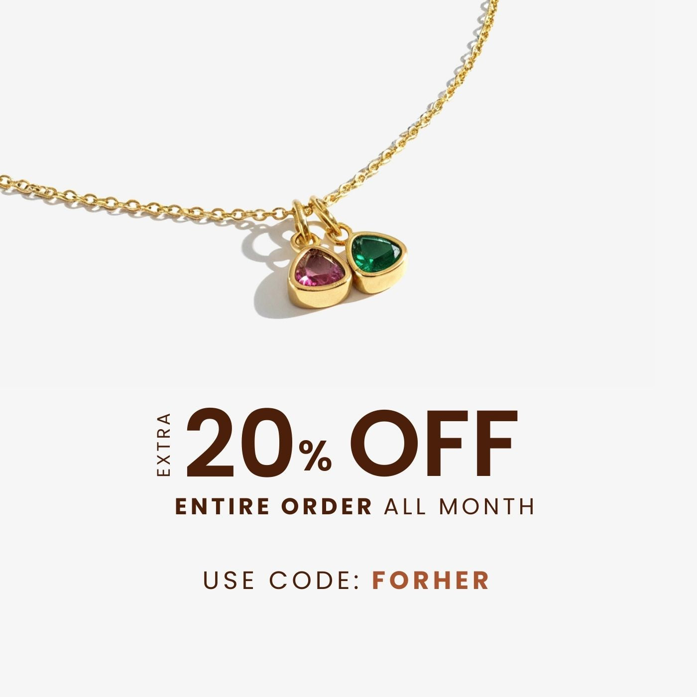 Gold necklace with two gemstone charms on a white background, with promotional text for a discount offer.