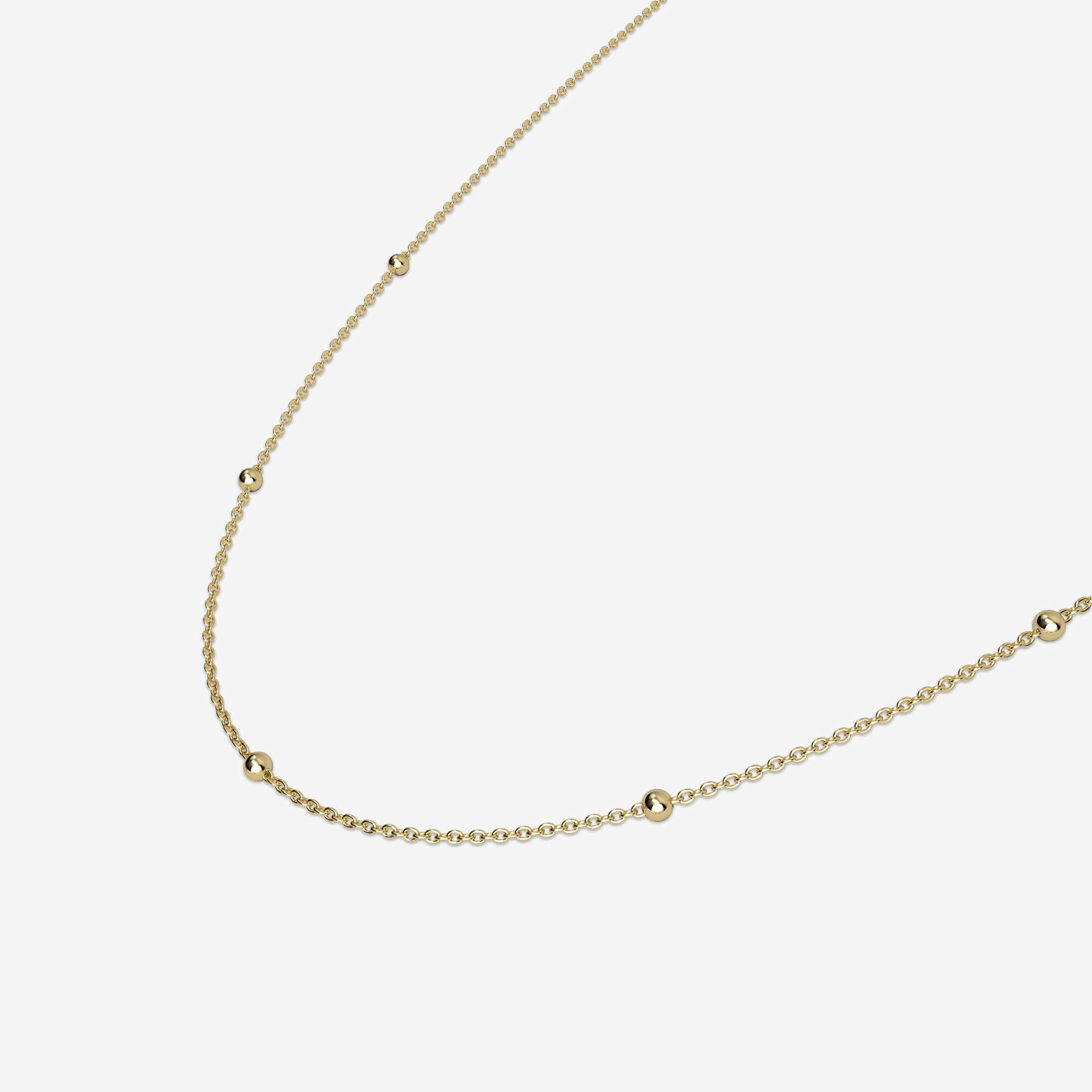 Gold necklace on a light beige background